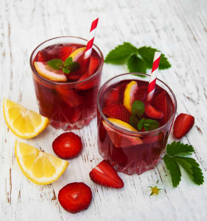 Glasses with strawberry drink on a wooden backgroundの写真素材