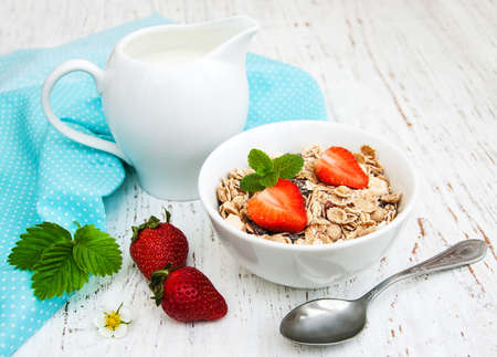 Muesli with strawberries on a old wooden backgroundの写真素材