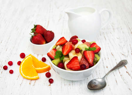 Salad with fresh fruits on a old wooden backgroundの写真素材