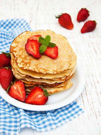 Pancakes with strawberries on a wooden backgroundの写真素材