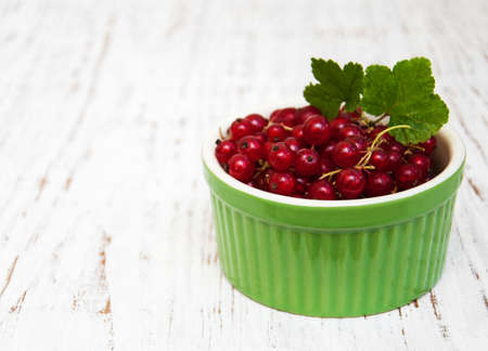 fresh red currant on a old wooden tableの写真素材
