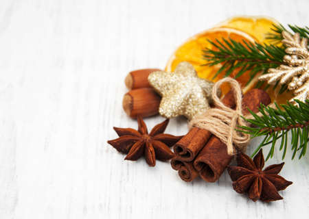 different kinds of spices nuts and dried oranges with christmas treeの写真素材