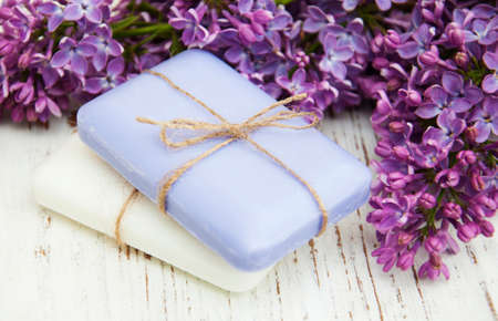 Natural handmade soap and lilac flowers on a wooden backgroundの写真素材