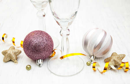 Champagne glass and christmas decor on a old wooden backgroundの写真素材