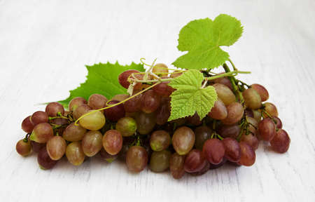 grape with leaf on a old wooden backgroundの写真素材