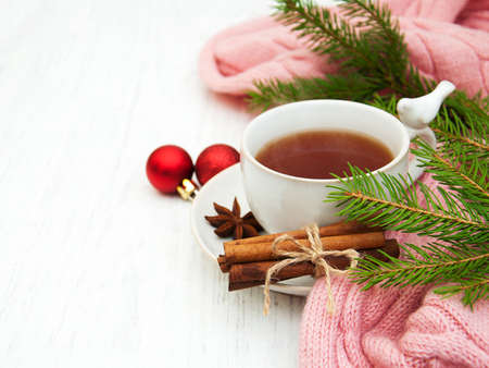 Cup of tea with christmas tree and scarfの写真素材