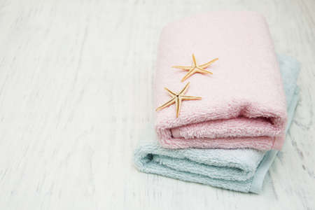 Cotton bath towels with starfish on a old wooden backgroundの写真素材
