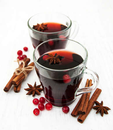 Glasses of mulled wine with spices on a old wooden backgroundの写真素材