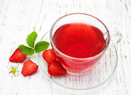 Fruit tea with strawberries  on a wooden tableの写真素材