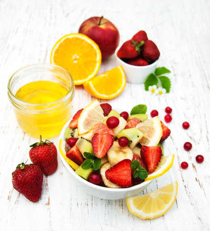 Salad with fresh fruits on a old wooden backgroundの写真素材