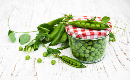 Jar with fresh peas on a old wooden backgroundの写真素材