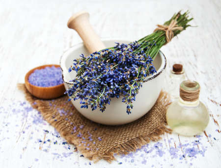 lavender oil with bath salt and fresh lavender on a old wooden backgroundの写真素材