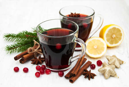 Glasses of mulled wine with spices on a old wooden backgroundの写真素材