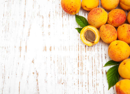 Fresh apricots on a old wooden backgroundの写真素材