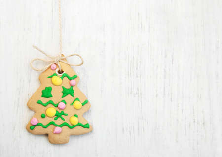 gingerbread christmas tree hanging over wooden backgroundの写真素材