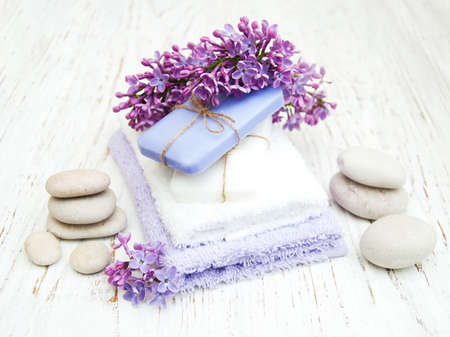 Spa concept - natural soap, towels and lilac flowersの写真素材