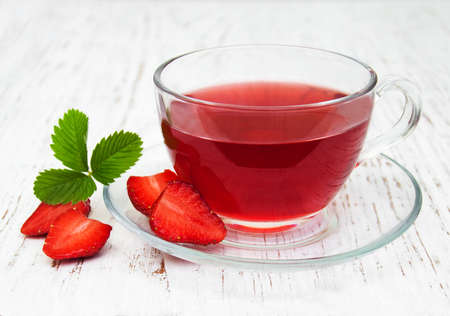 Fruit tea with strawberries  on a wooden tableの写真素材