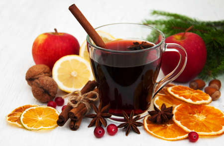 Glasses of mulled wine with spices on a old wooden backgroundの写真素材