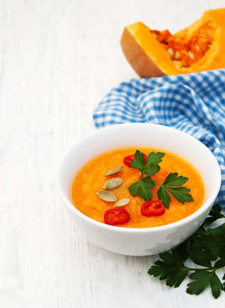 Bowl with Pumpkin soup on a old wooden backgroundの写真素材
