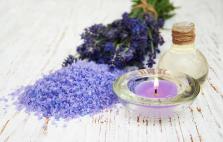 Lavender, sea salt and candle on a wooden backgroundの写真素材