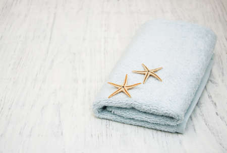 Cotton bath towel with starfish on a old wooden backgroundの写真素材
