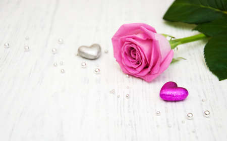 Pink Rose on a old wooden tableの写真素材