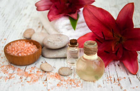 Spa products with pink  lily on a old wooden backgroundの写真素材