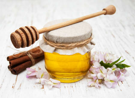 honey with acacia blossoms on a wooden backgroundの写真素材