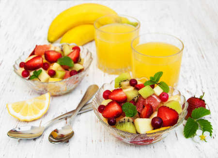 Salad with fresh fruits on a old wooden backgroundの写真素材