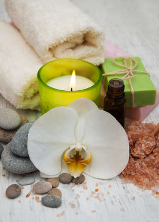 Orchids, candle, towel and handmade soap on a old wooden backgroundの写真素材