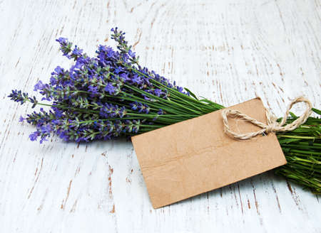 lavender flowers with tag on a old wooden backgroundの写真素材
