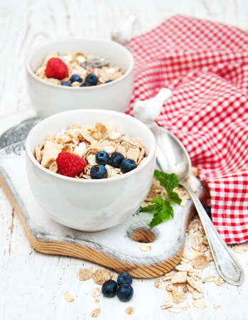 breakfast with fresh berries on a old wooden tableの写真素材