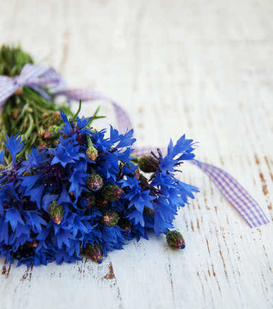 blue cornflowers on a old white wooden backgroundの写真素材