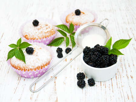 muffins with blackberry on a old wooden backgroundの写真素材