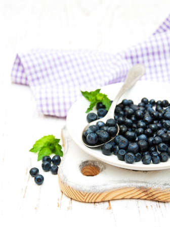 Plate with Blueberries on a old wooden backgroundの写真素材