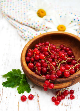 fresh red currant on a old wooden tableの写真素材