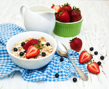 Muesli with strawberries on a old wooden backgroundの写真素材