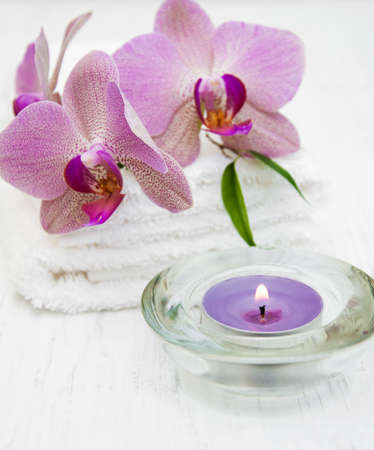 Pink orchids and towels on a wooden backgroundの写真素材
