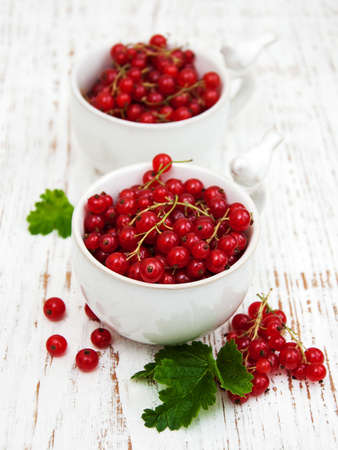 fresh red currant on a old wooden tableの写真素材