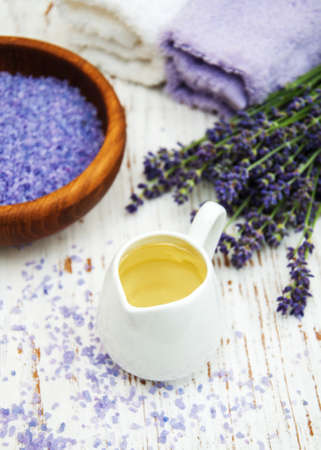 Lavender with essencial oil and candle on a wooden backgroundの写真素材