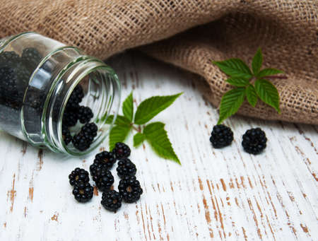 Jar with Blackberries on a old wooden backgroundの写真素材