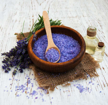 lavender oil with bath salt and fresh lavender on a old wooden backgroundの写真素材