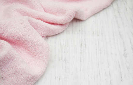 Pink bath towel on a old wooden backgroundの写真素材
