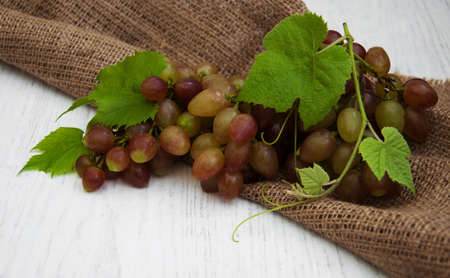 grape with leaf on a old wooden backgroundの写真素材