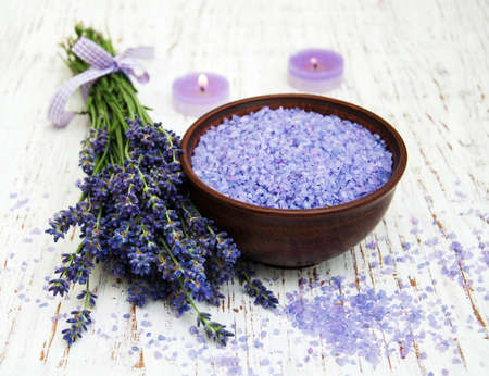 Lavender, sea salt and candle on a wooden backgroundの写真素材