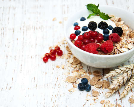 breakfast with fresh berries on a old wooden tableの写真素材