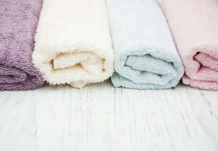 colorful spa towels on a wooden backgroundの写真素材