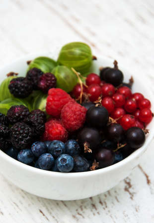 bowl with berries on a old wooden backgroundの写真素材