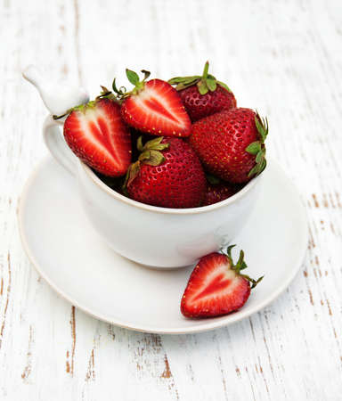 Cup with strawberries on a old wooden backgroundの写真素材