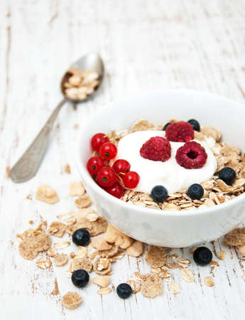 breakfast with fresh berries on a old wooden table